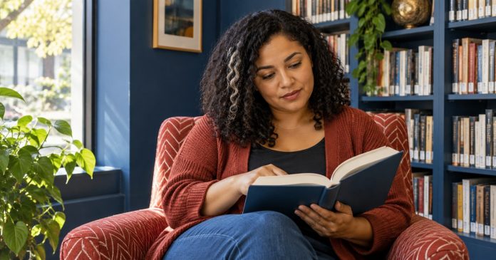 Do You Have to Believe in Reiki? What Belief Changes, and What It Doesn't — cover A woman reads thoughtfully in a library armchair.
