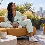 The Benefits of Reiki Healing for Stress: A Short Guide and Where to Read More A young woman takes a quiet seated pause in a rooftop garden.