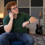 Boundary Phrases for Draining Conversations: Practical Examples A man checks the time during a phone conversation in a home music room.