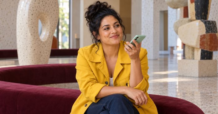 Kindred Spirit vs Soulmate: The Difference, Honestly, in Brief — editorial cover A woman records a friendly voice message while sitting in an arts-center lobby.