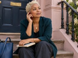 Signs You Are in a Karmic Relationship: The Pattern, the Useful Reading, and the Line Not to Cross A woman sits on front steps speaking on a red phone.