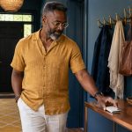 How to Protect Your Aura: Spiritual Practices and Six Practical Boundaries A man sets his phone face down on an entryway console.