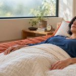 Astral Projection: Spiritual Interpretations, Experiences and Research Limits A woman rests on a made futon in a quiet bedroom.