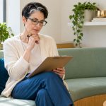 Reiki and Your Health: A Patient’s Guide to Using It Alongside Medical Care A woman reviews a clipboard of questions in a quiet resource room.