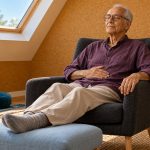 Chakra Work With Reiki: A 20-Minute Hands-On Body Scan, Without the Energy Claims An older man rests a hand on his abdomen during a comfortable seated body scan.
