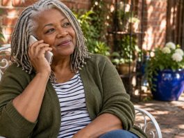 Why People Confide in You: The Listening Presence, Honestly, in Brief A silver-haired woman listens attentively on a white mobile phone in a sheltered courtyard.