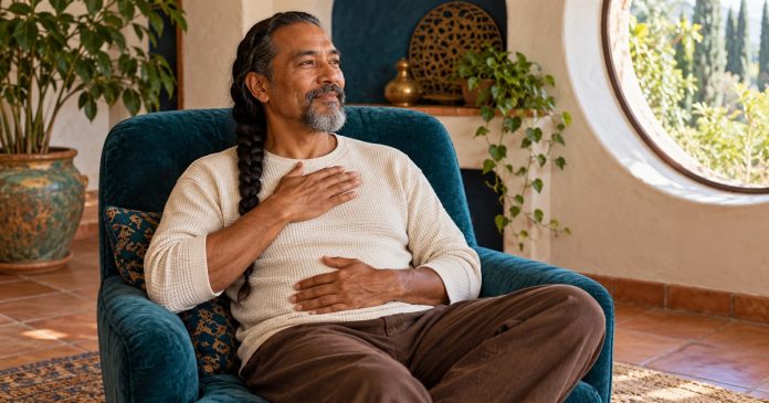 Self-Reiki Practice: A Comfortable Routine and Clear Limits — editorial cover A seated man rests his hands lightly on his chest and abdomen during a quiet self-practice.